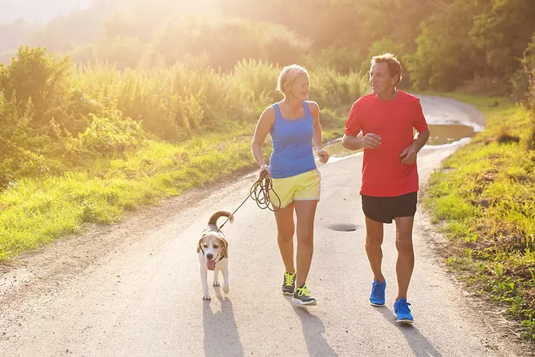 A man woman and dog jogging
